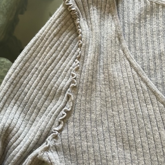 A gray sweater with a lot of detail on the shoulder and pearls on the sleeve. - Picture 3 of 3